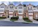 Charming townhomes featuring stone accents, private garages, and well-maintained landscaping at 5113 Lady Of The Lake Dr, Raleigh, NC 27612