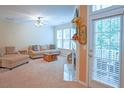 Comfortable living area has fireplace, with direct access to outdoor space and plenty of natural light at 5113 Lady Of The Lake Dr, Raleigh, NC 27612