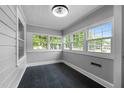 Bright sun room with lots of windows and dark tile flooring at 601 Acorn St, Burlington, NC 27215