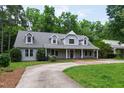 Attractive home with dormer windows, a brick walkway, and a spacious driveway leading to the property at 7009 Brecken Ridge Ave, Raleigh, NC 27615