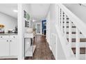 Hallway features wood floors, stairs, and decor at 7365 Sandy Creek Dr, Raleigh, NC 27615