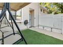 Relaxing front porch featuring a swing, artificial turf, and a pathway with garden lights at 7365 Sandy Creek Dr, Raleigh, NC 27615