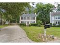 Traditional two-story home with a well-manicured lawn and mature trees at 8116 Bentwood Pl, Raleigh, NC 27615