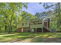 Back exterior showcasing the deck, yard, and access to home at 821 Stoneybrook Dr, Sanford, NC 27330