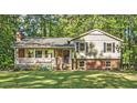 Charming two-story home featuring a brick and siding exterior, complemented by a welcoming front porch at 821 Stoneybrook Dr, Sanford, NC 27330