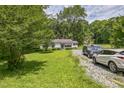 Charming single-story home with a well-maintained front lawn and gravel driveway at 8635 Old Us 421 S, Bear Creek, NC 27207