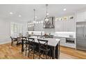 Bright kitchen with island seating, stainless steel appliances, and hardwood flooring at 911 Canterbury Rd, Raleigh, NC 27607