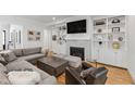 Cozy living room featuring custom built-ins, a fireplace, and hardwood floors at 911 Canterbury Rd, Raleigh, NC 27607