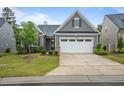 Attractive one-story home featuring a two car garage, neat landscaping, and a well-maintained lawn at 1010 Sandbar Ln, Durham, NC 27703