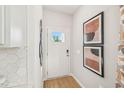 Bright entryway features a glass door, white walls, and modern decorative artwork at 1037 Winding Spring Dr, Mebane, NC 27302