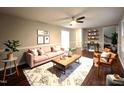 Inviting living room featuring hardwood floors, a ceiling fan, and ample natural light at 108 W Marsha Gayle Ct, Fuquay Varina, NC 27526