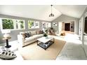 Bright open living room with white tile floors, a vaulted ceiling, and lots of windows at 108 W Marsha Gayle Ct, Fuquay Varina, NC 27526