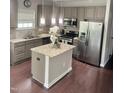Eat-in kitchen featuring granite countertops, stainless appliances, and wood flooring at 1116 Powder, Fuquay Varina, NC 27526