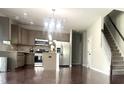 Bright kitchen with stainless steel appliances, granite countertops, and a stylish island, perfect for cooking and entertaining at 1116 Powder, Fuquay Varina, NC 27526
