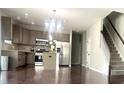 Open kitchen with stainless steel appliances, granite countertops, and a central island at 1116 Powder, Fuquay Varina, NC 27526