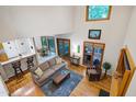 Open-concept living room with soaring ceilings, hardwood floors, and floor-to-ceiling windows with an adjacent dining area at 112 Hidden Bluff Ln, Cary, NC 27513