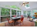 Sunroom featuring a vaulted ceiling, lots of natural light, a ceiling fan, and a table with chairs at 112 Hidden Bluff Ln, Cary, NC 27513