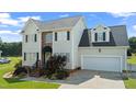 Charming two-story home features a two-car garage and beautifully maintained lawn at 115 Spring Branch Dr, Four Oaks, NC 27524