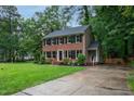 Traditional brick home with a well-kept lawn and a paved driveway at 11816 Stannary Pl, Raleigh, NC 27613
