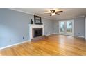 Spacious living room with hardwood floors, fireplace, and natural light at 11816 Stannary Pl, Raleigh, NC 27613