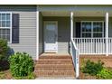 Close up of the front door with brick steps and the house number 12449 clearly displayed at 12449 W Pamlico St, Middlesex, NC 27557