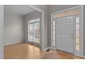 Bright foyer with hardwood floors, white trim, and a large window providing natural light at 13121 Sargas St, Raleigh, NC 27614