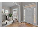 Bright foyer featuring hardwood floors, sidelight windows, and an adjacent sitting room at 13121 Sargas St, Raleigh, NC 27614