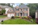 Beautiful two-story brick home with dark shutters, manicured lawn, and an attached two-car garage at 13121 Sargas St, Raleigh, NC 27614