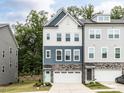 Charming townhome featuring a stone facade, attached garage, and a welcoming front entrance at 2008 Van Hook Ln, Apex, NC 27502