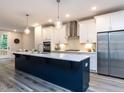 Modern kitchen featuring a large island, stainless steel appliances, and ample cabinet space at 2008 Van Hook Ln, Apex, NC 27502