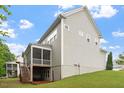 Back of the house featuring a screened porch, deck, and well-maintained yard at 213 Preatonwood Dr, Apex, NC 27539