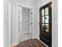 Inviting entryway with hardwood floors, a dark front door with glass panes, and neutral paint at 248 Daniel Ridge Rd, Wendell, NC 27591
