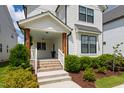 Charming front porch with wood columns, brick stairs, and manicured landscaping at 248 Daniel Ridge Rd, Wendell, NC 27591