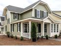 Charming home showcasing an inviting porch, complemented by mature landscaping for enhanced curb appeal at 2641 Sidford Aly, Raleigh, NC 27608