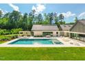 A refreshing pool and spa create a serene outdoor retreat, complete with lounge areas and manicured landscaping at 295 Lystra Preserve Dr, Chapel Hill, NC 27517