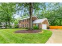 Spacious brick home with a large yard, driveway, and a detached garage at 3027 Truitt Dr, Burlington, NC 27215