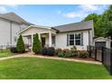 Attractive single-Gathering home boasting manicured lawn, stone pathway, and colorful garden beds at 305 Georgetown Rd, Raleigh, NC 27608