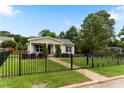 Beautiful home with a well-kept lawn, stone path, and black fence creating a welcoming entrance at 305 Georgetown Rd, Raleigh, NC 27608