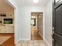 Bright foyer with tile flooring leading into a home with an open floor plan and hardwood floors at 3421 Angus Rd, Durham, NC 27705