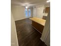 Bright open living area with wood floors and a kitchen bar at 3522 Ivy Commons Dr # 101, Raleigh, NC 27606
