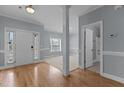 Bright foyer with hardwood floors, white trim, and view of the bathroom at 39 Mcguire Ln, Clayton, NC 27527