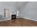 Cozy living room featuring a fireplace, hardwood floors, and ample natural light at 39 Mcguire Ln, Clayton, NC 27527