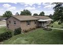 Brick home on a lush green lawn, complete with a covered front porch at 403 E Mcpherson Dr, Mebane, NC 27302