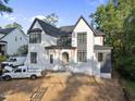 Beautiful new construction exterior with gray roof, black frame windows, white brick and covered entry at 5013 Coronado, Raleigh, NC 27609