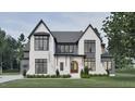 Beautiful exterior featuring covered entry, black trim windows, gray roof and manicured lawn at 5013 Coronado, Raleigh, NC 27609