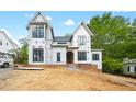 New home under construction featuring black window frames and an arched doorway at 5013 Coronado, Raleigh, NC 27609