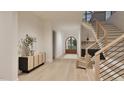 Elegant foyer with light hardwood floors, stairs and a view of the arched entryway at 5013 Coronado, Raleigh, NC 27609