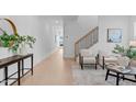 Bright, open living room with hardwood floors and neutral decor, adjacent to staircase at 5041 Lundy Dr # 102, Raleigh, NC 27606