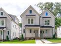 Charming two-story townhome with modern farmhouse design, complemented by a well-manicured lawn at 5061 Lundy Dr # 101, Raleigh, NC 27606