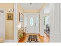 Inviting foyer boasts hardwood floors and detailed trim work, offering a warm welcome to the home at 5405 Bluet Ct, Holly Springs, NC 27540